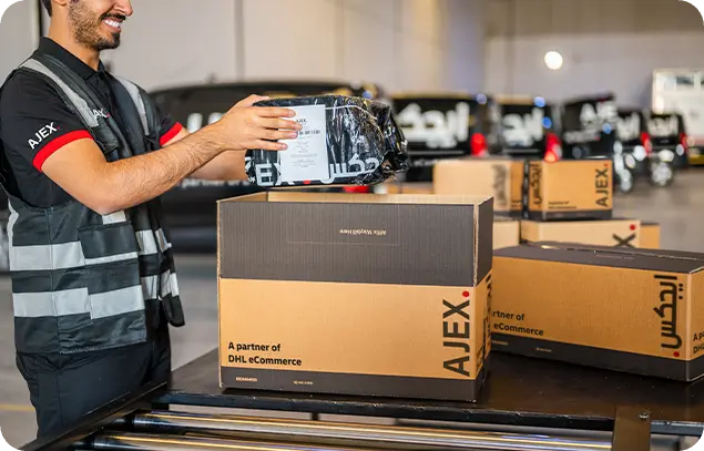 An AJEX employee keeping the items in a AJEX box for delivery